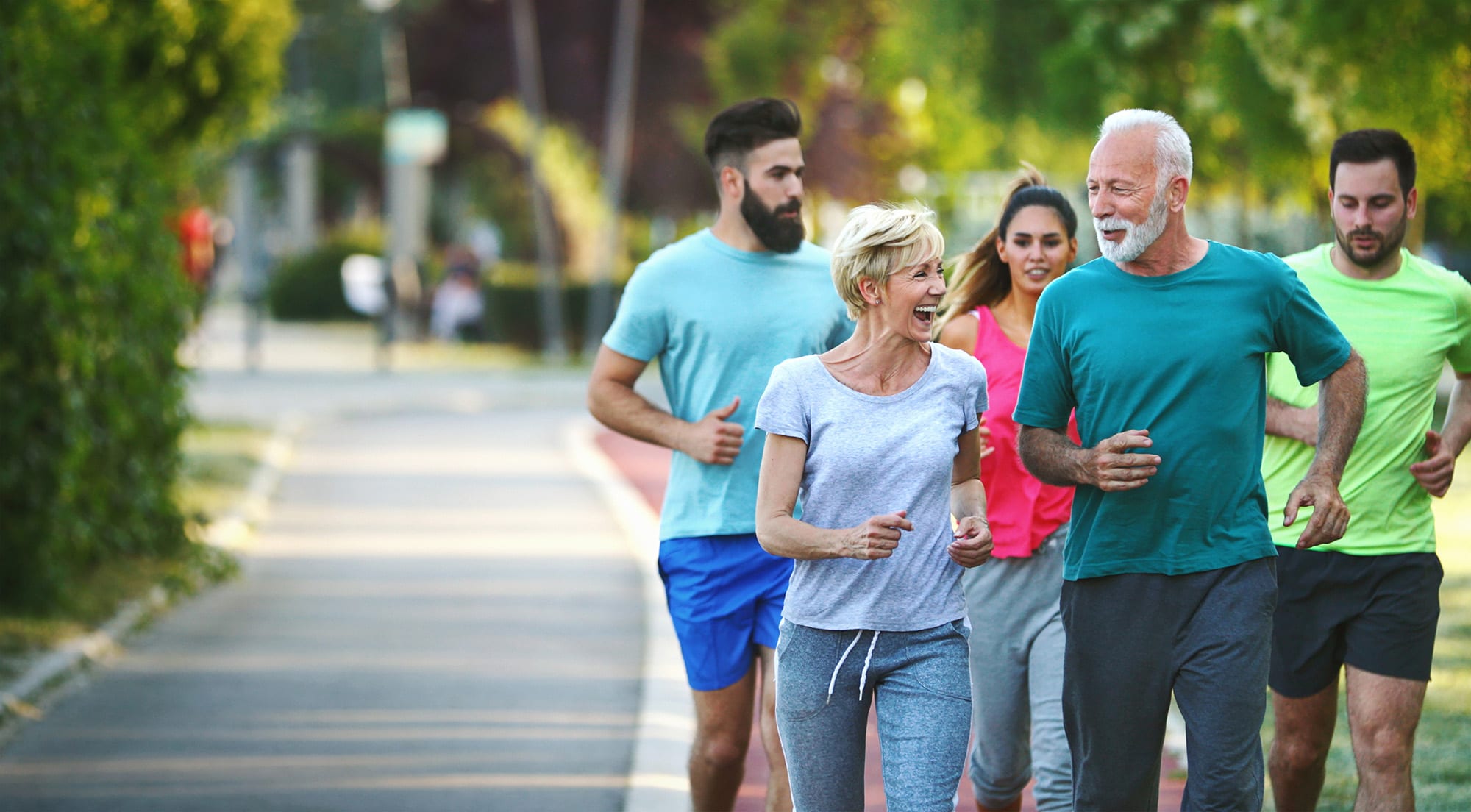 Senior couple on a run with 3 younger adults