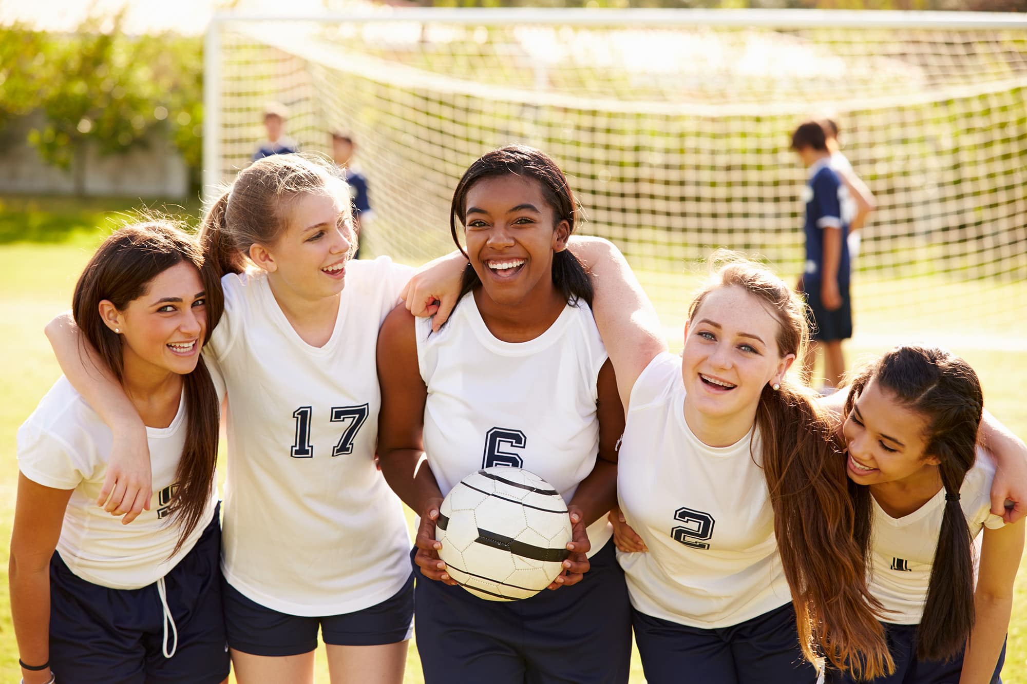 Smiling members of female high school soccer team
