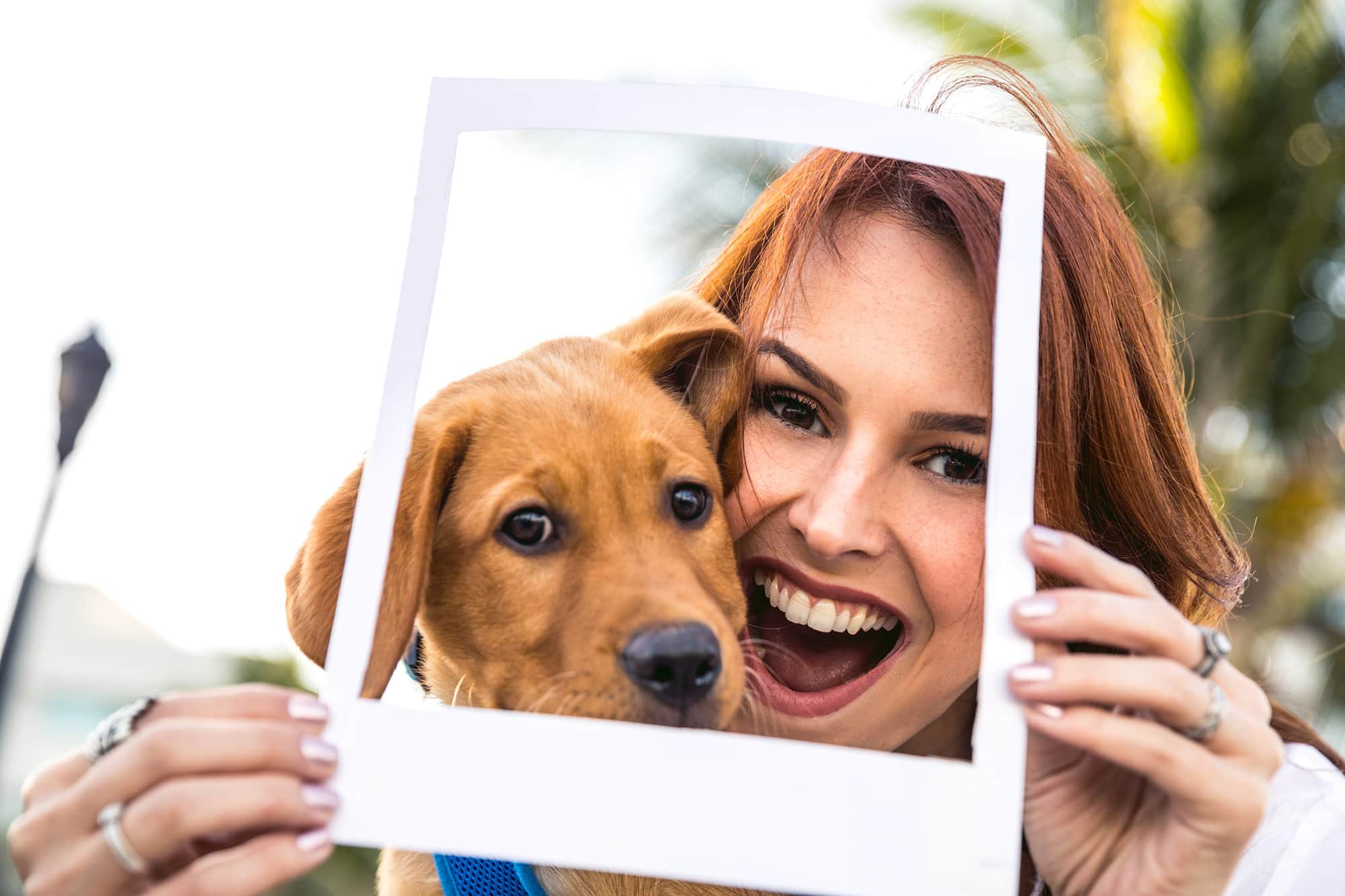 Happy redhead woman posing with puppy